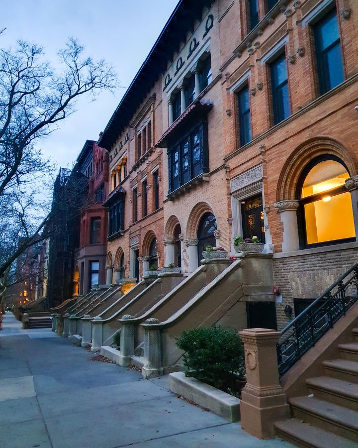 Park Slope Brooklyn New York City USA Non-Touristy Activities for Return Visitors to New York City A street in Park Slope New York City, USA. The street is lined with three story brownstone buildings with stairs leading up to them. On the left is a path with bare trees on it too "Non-Touristy Activities for Return Visitors to New York City"