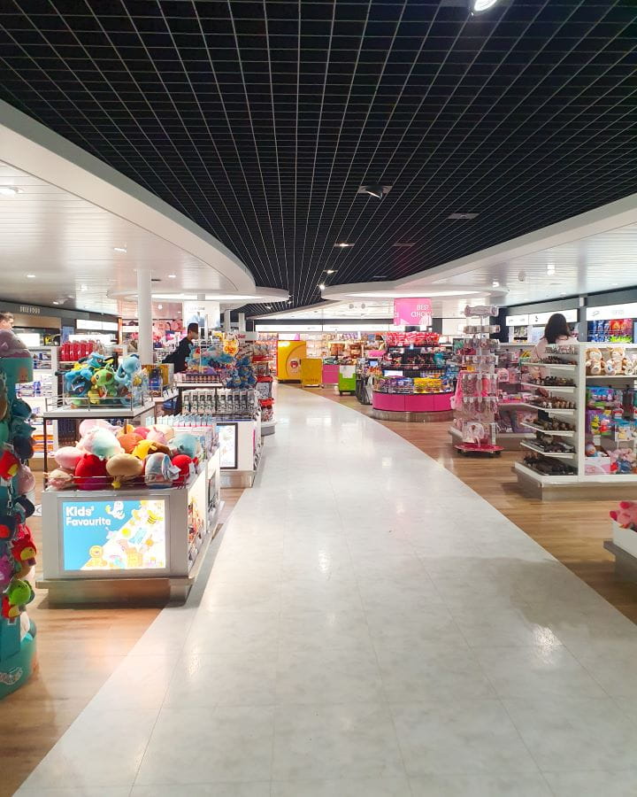 Tallink How To Do Helsinki and Tallinn In a Weekend On the Tallink ship. There's a white floor running through the middle of the photo with stands on either side with things to buy. It's the kids section so there's lots of toys and sweets. How To Do Helsinki and Tallinn In a Weekend