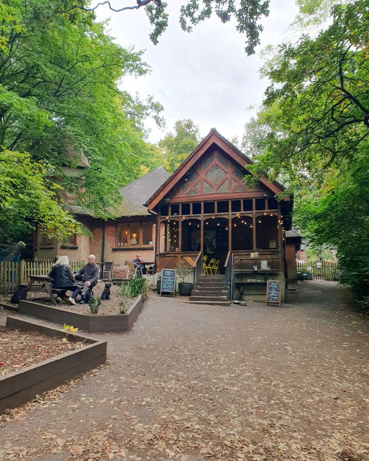 United Kingdom Queens Wood café Nine Less Touristy But Wonderful Parks to Visit in London Queen's Wood Café in Queenswood, London. It's a cute little wooden and stone café with pointed rooves and fairy lights. There's people sitting out the front and green trees all around. Nine Less Touristy But Wonderful Parks to Visit in London